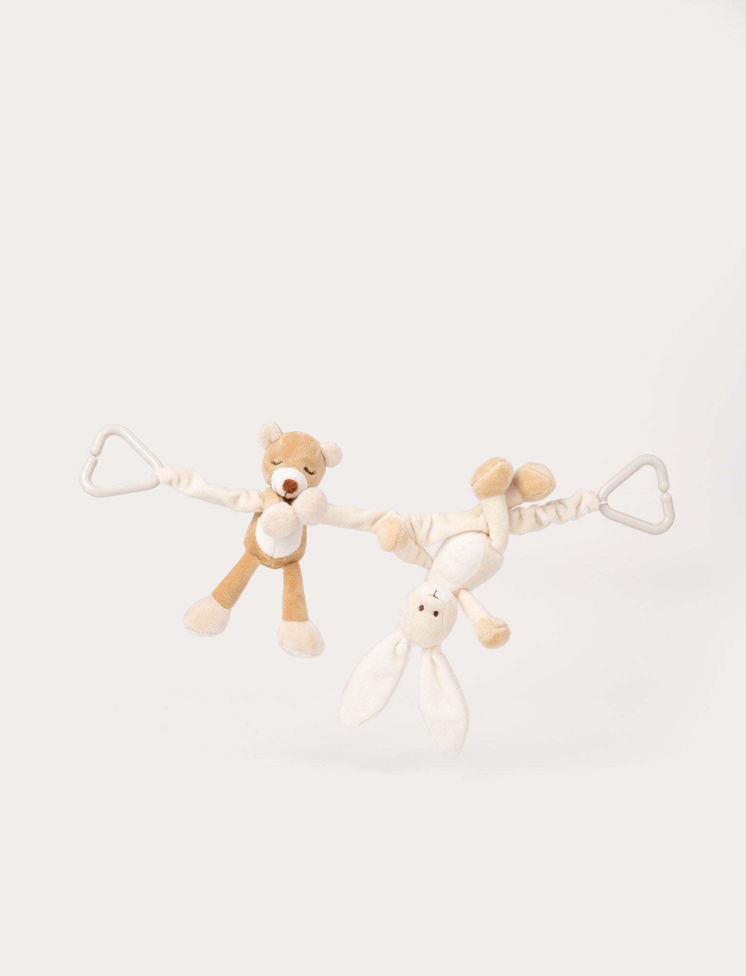  Image of Soft stroller toy with plush teddy bear and bunny figures, beige and white, attached to flexible strap with two clips.