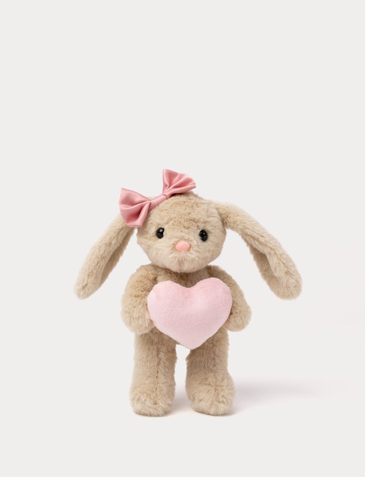 Soft beige bunny plush toy with pink bow holding a pink heart