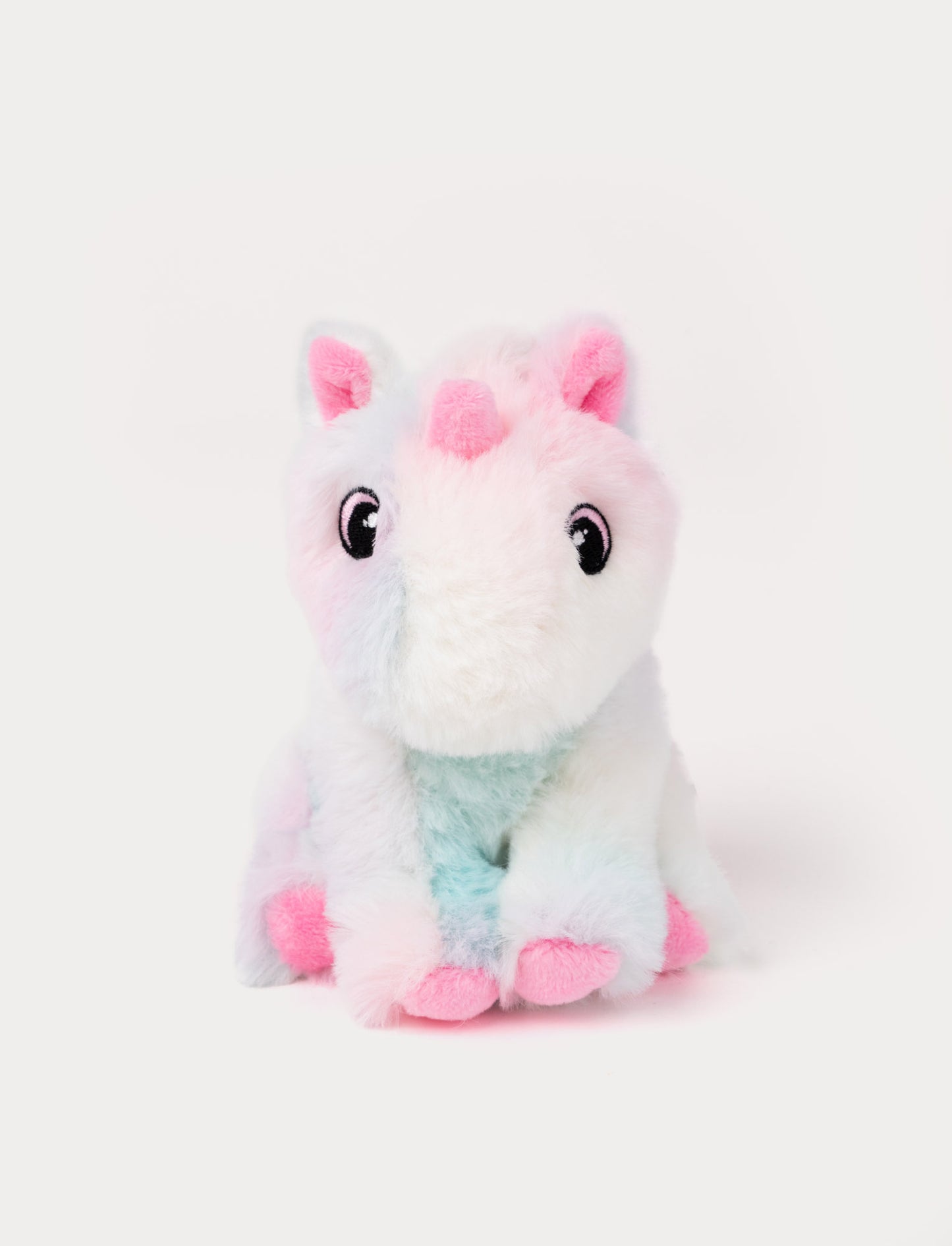 Fluffy pink unicorn plush with pastel pink and blue accents.