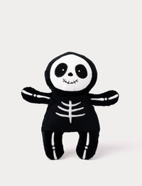 Soft black skeleton plush toy with glow-in-the-dark white effect.
