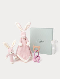 Pink bunny-themed baby comforter and teether, and rattle in a green gift box