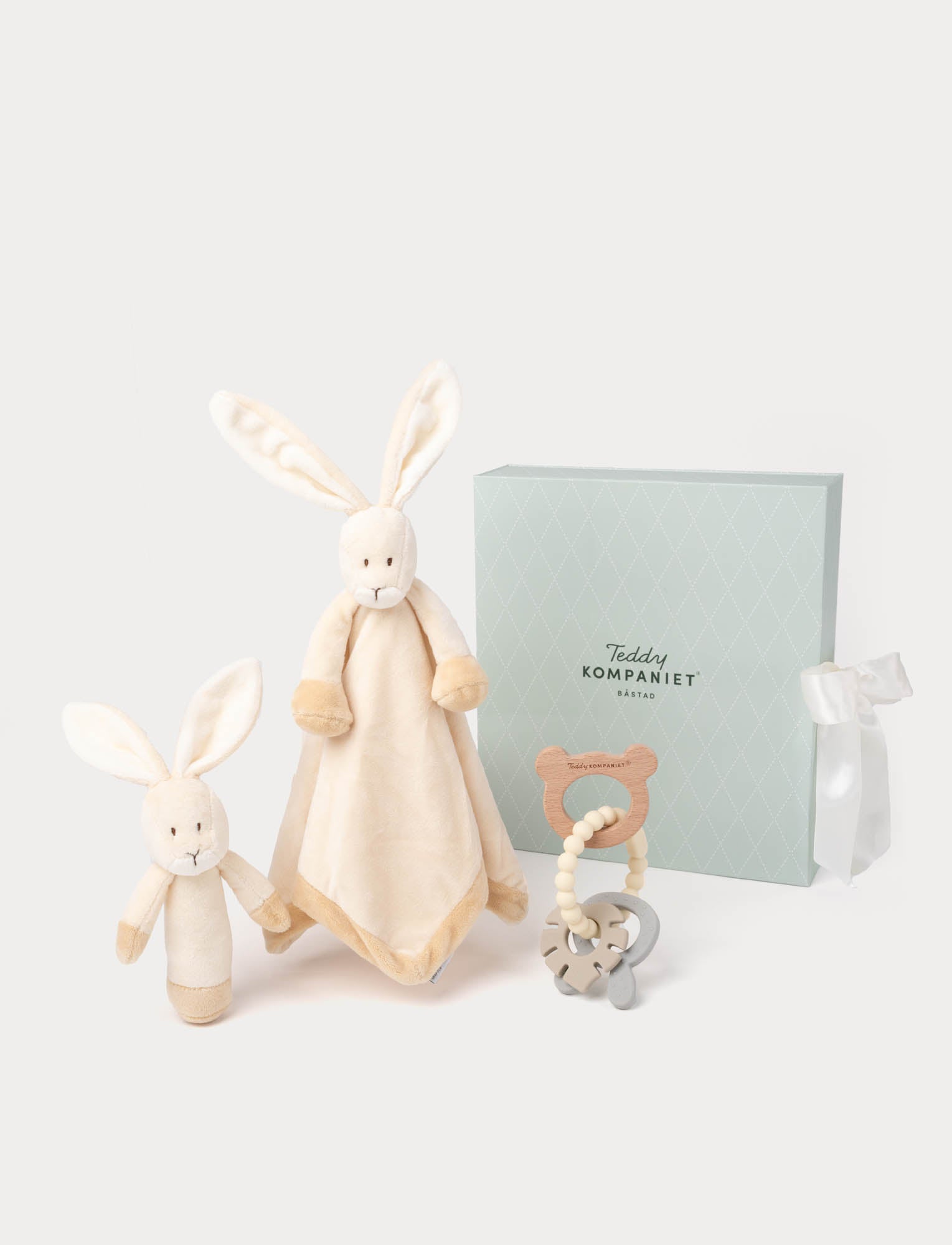  Image of Beige bunny-themed baby comforter, teether, and rattle in a green gift box