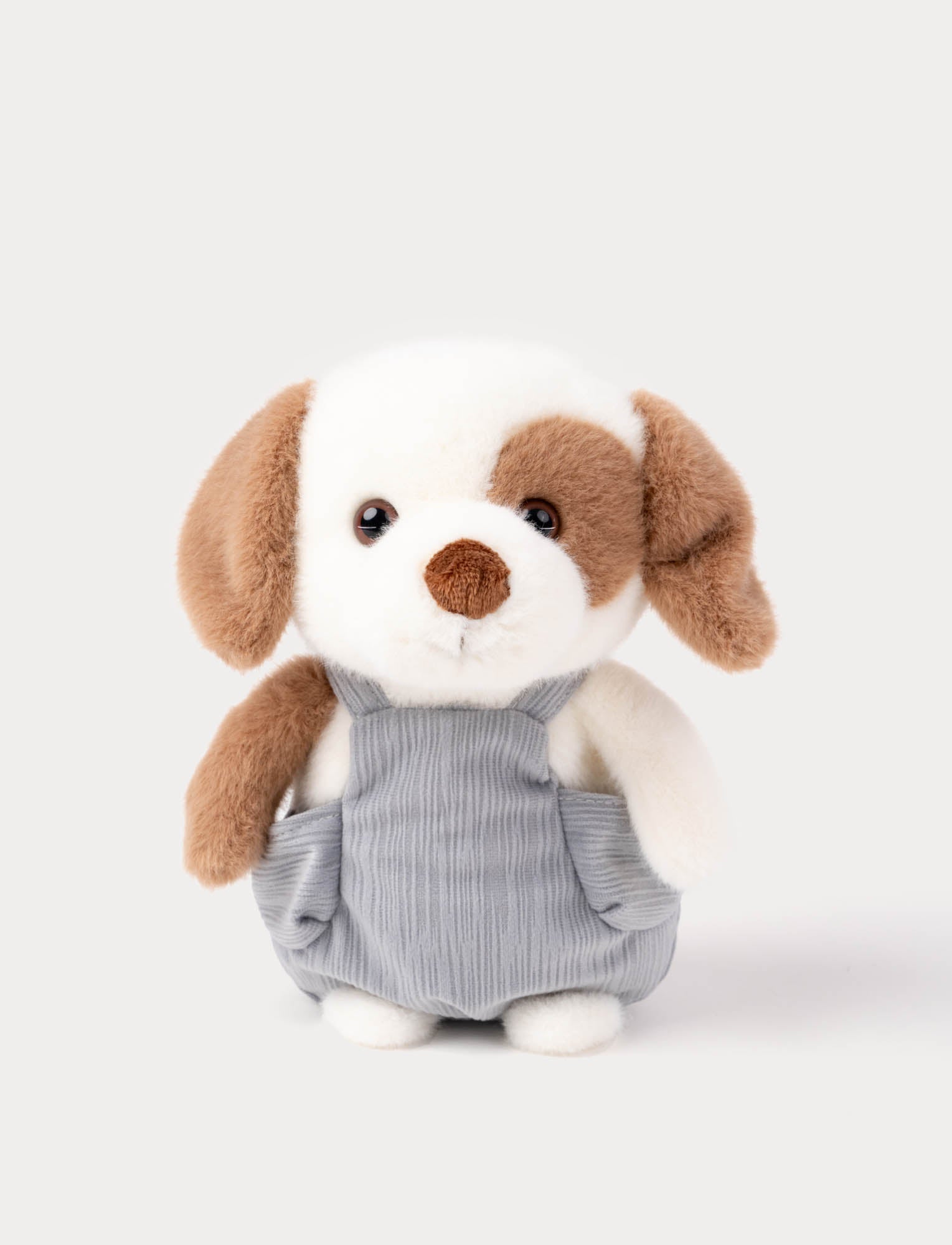  Image of Stuffed dog toy with brown ears and a gray dungarees on a white background