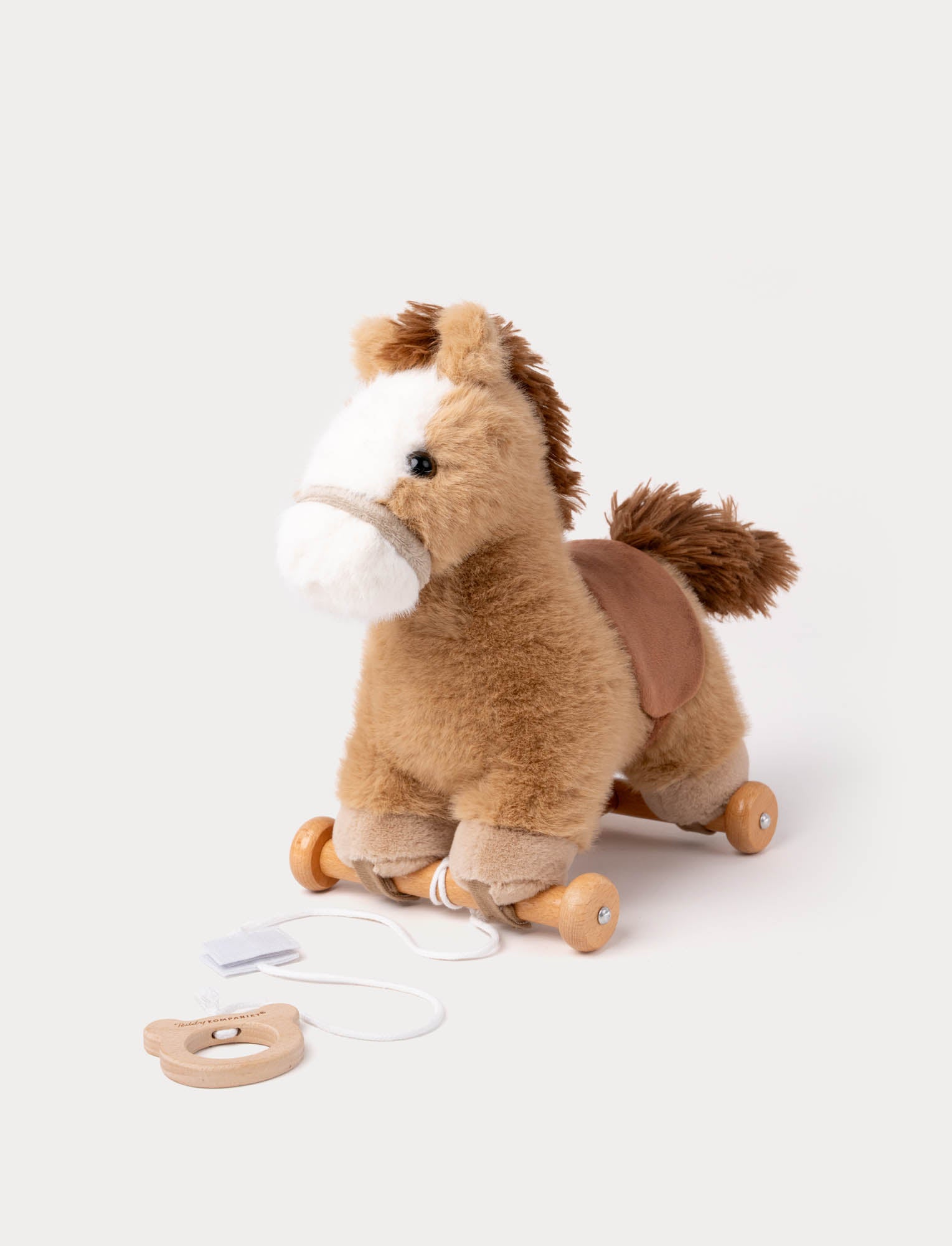  Image of Soft brown and white plush pull-along horse toy with wooden wheels and string handle.