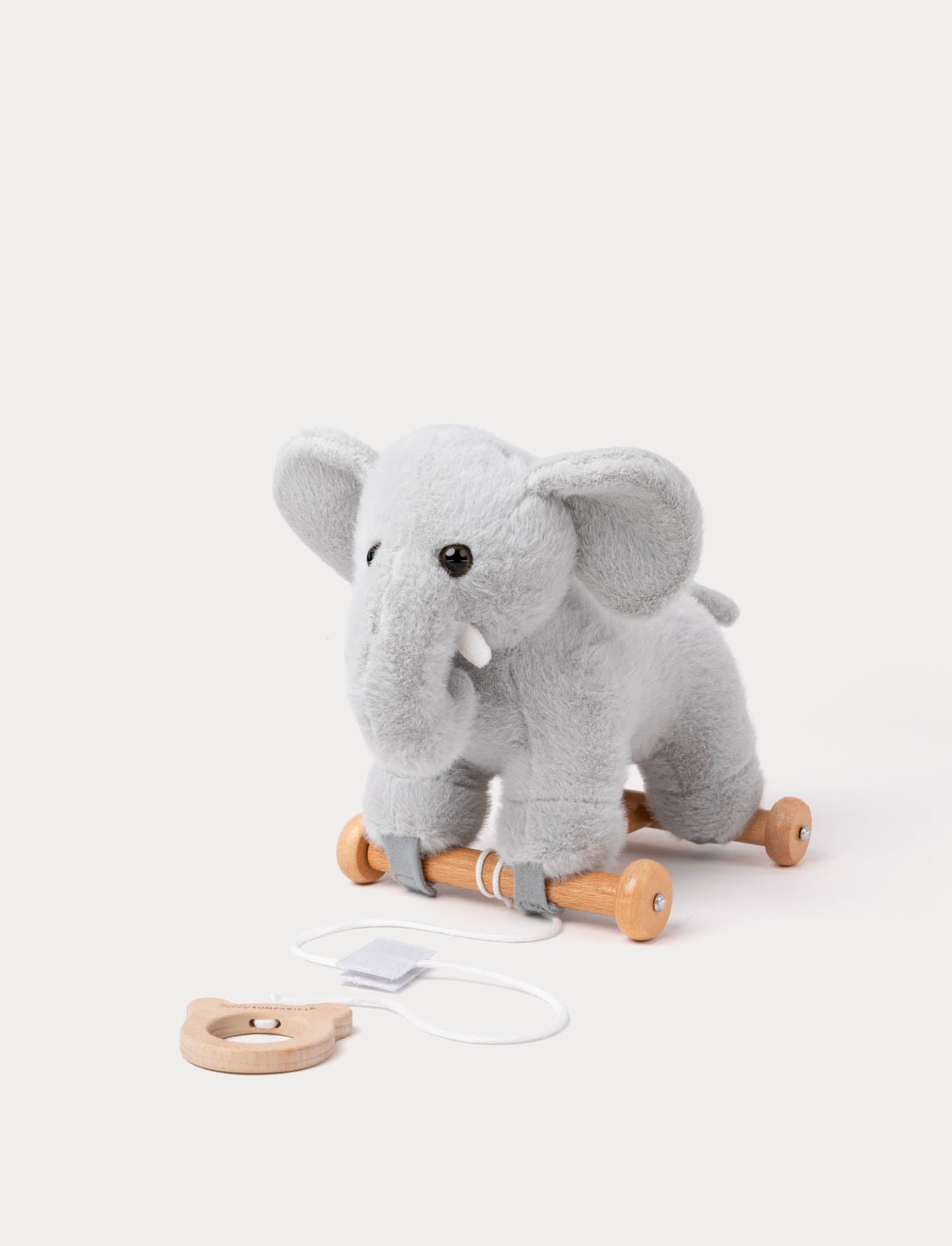  Image of Soft grey plush elephant pull toy on wooden wheels with attached string handle.