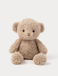 Plush teddy bear in beige with curly fur