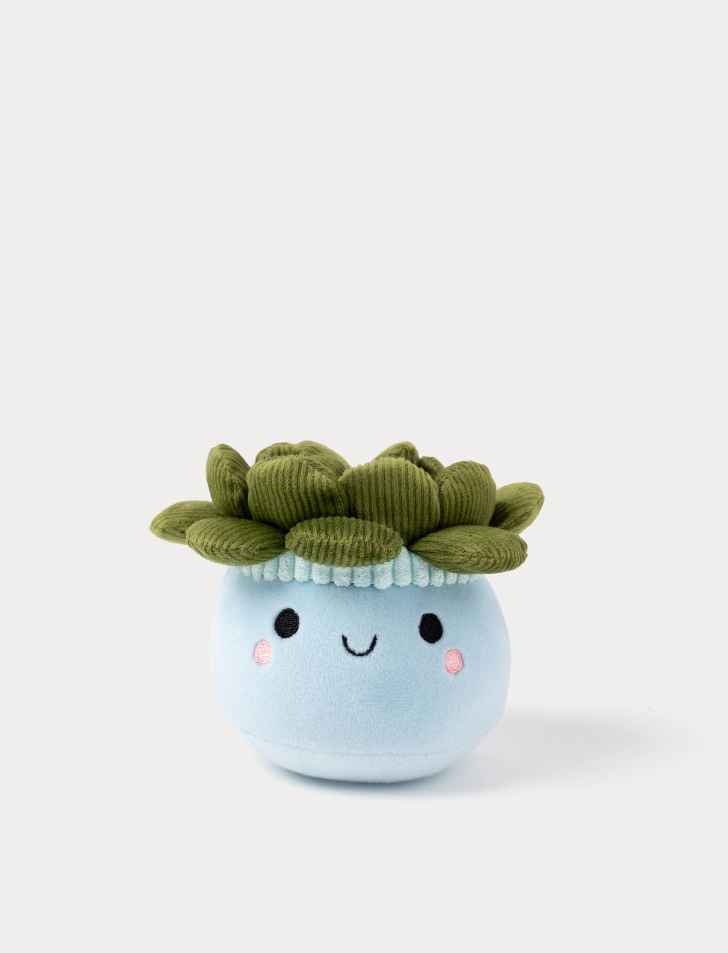 Plush toy flowerpot with a face and green leaves on a white background