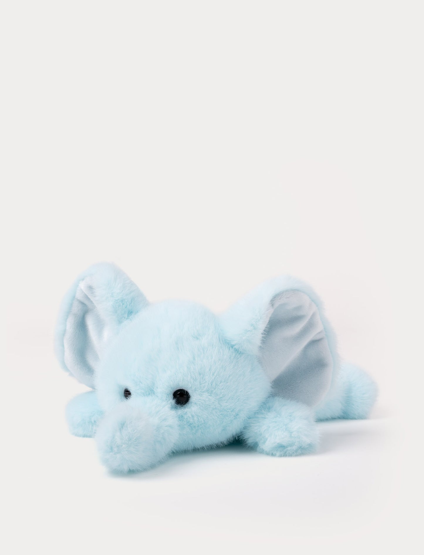Light blue plush elephant toy on a white background