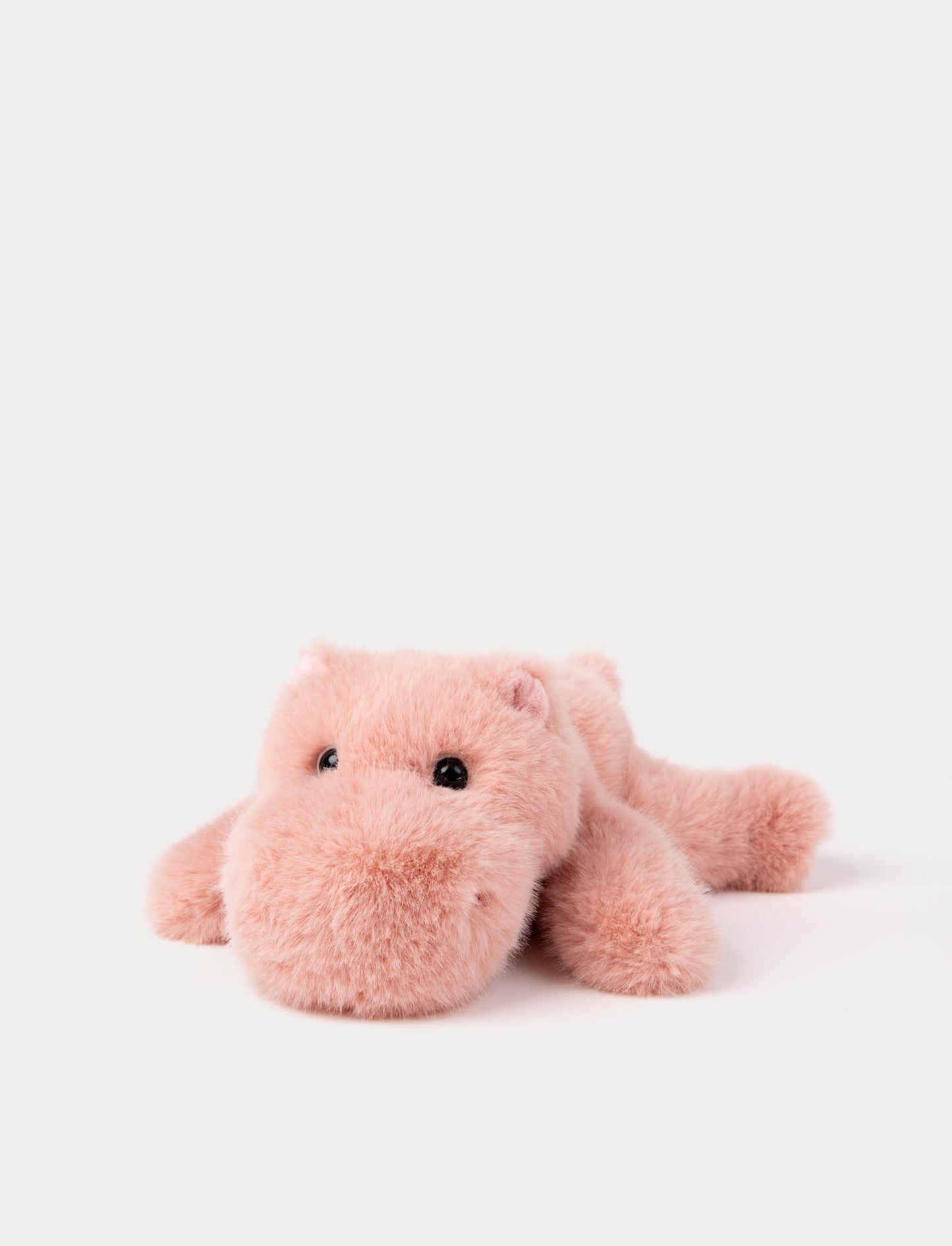 Pink plush hippo lying down