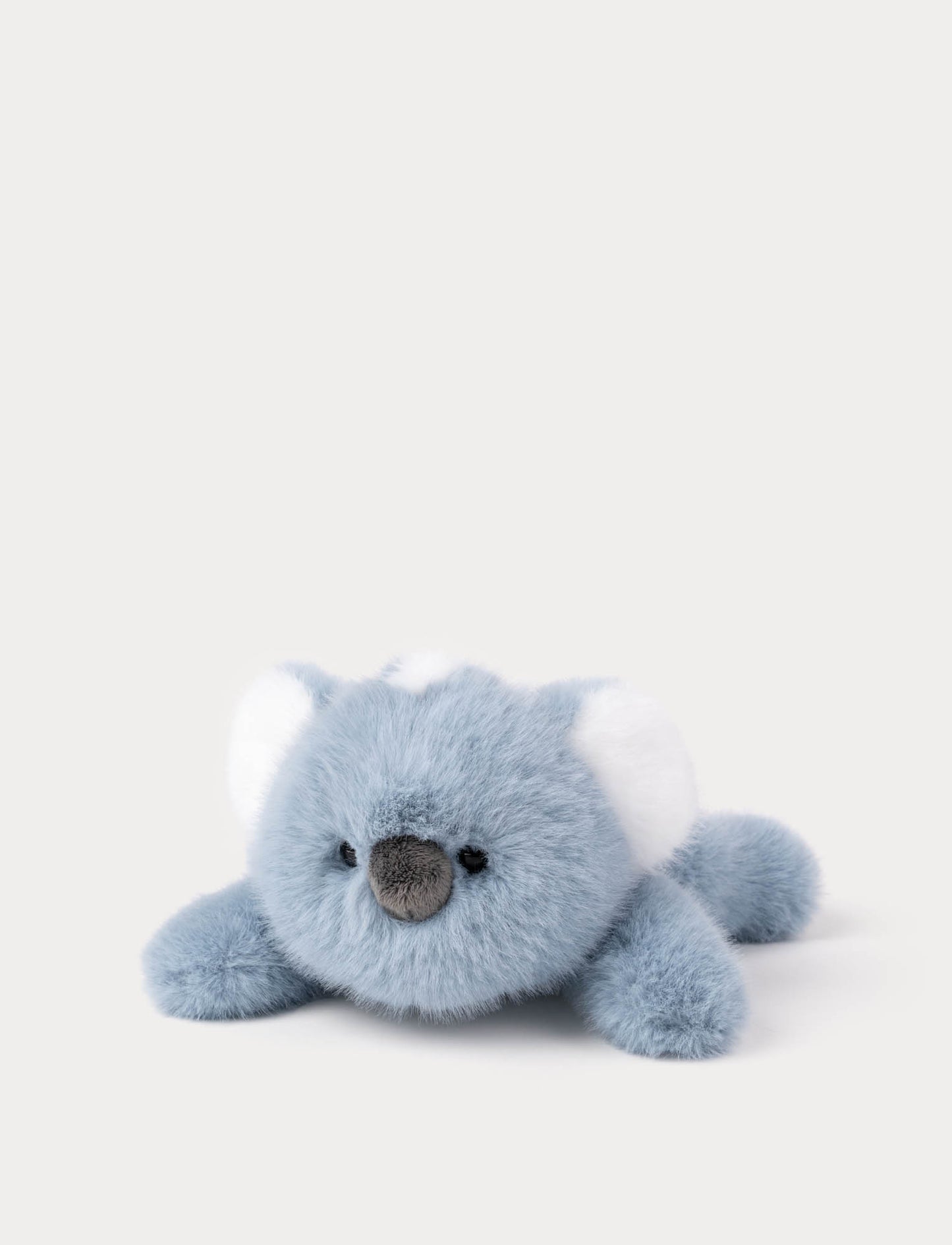 Blue plush koala toy lying down 