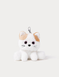 Plush keychain of a white cat with beige ears on a light gray background