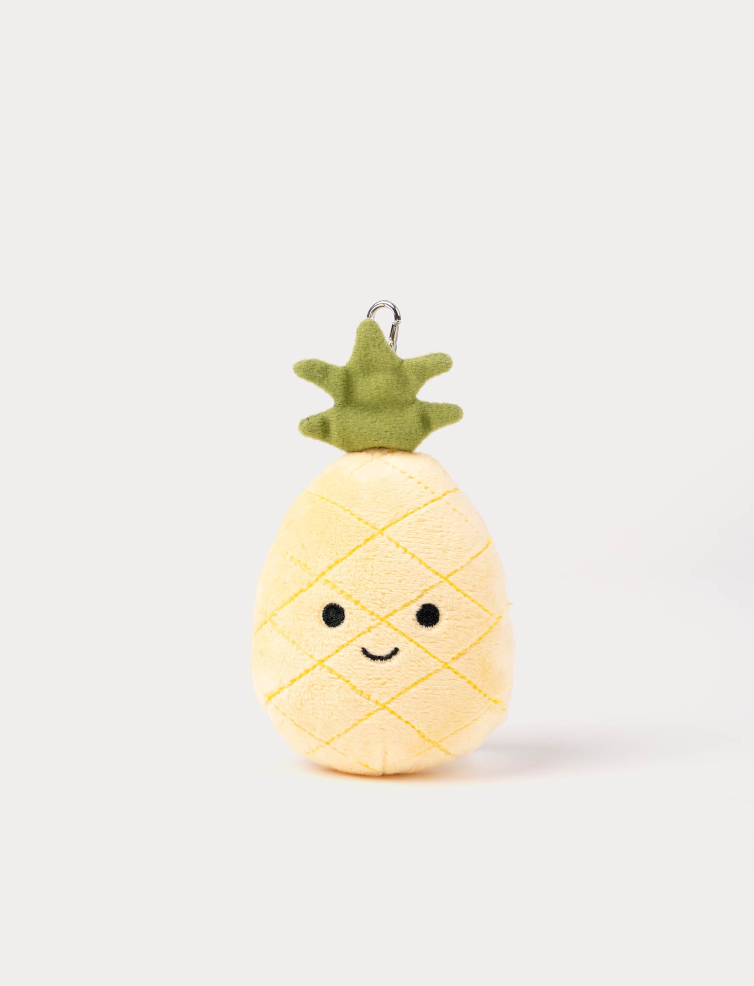  Image of Plush pineapple keychain with a happy face on a white background