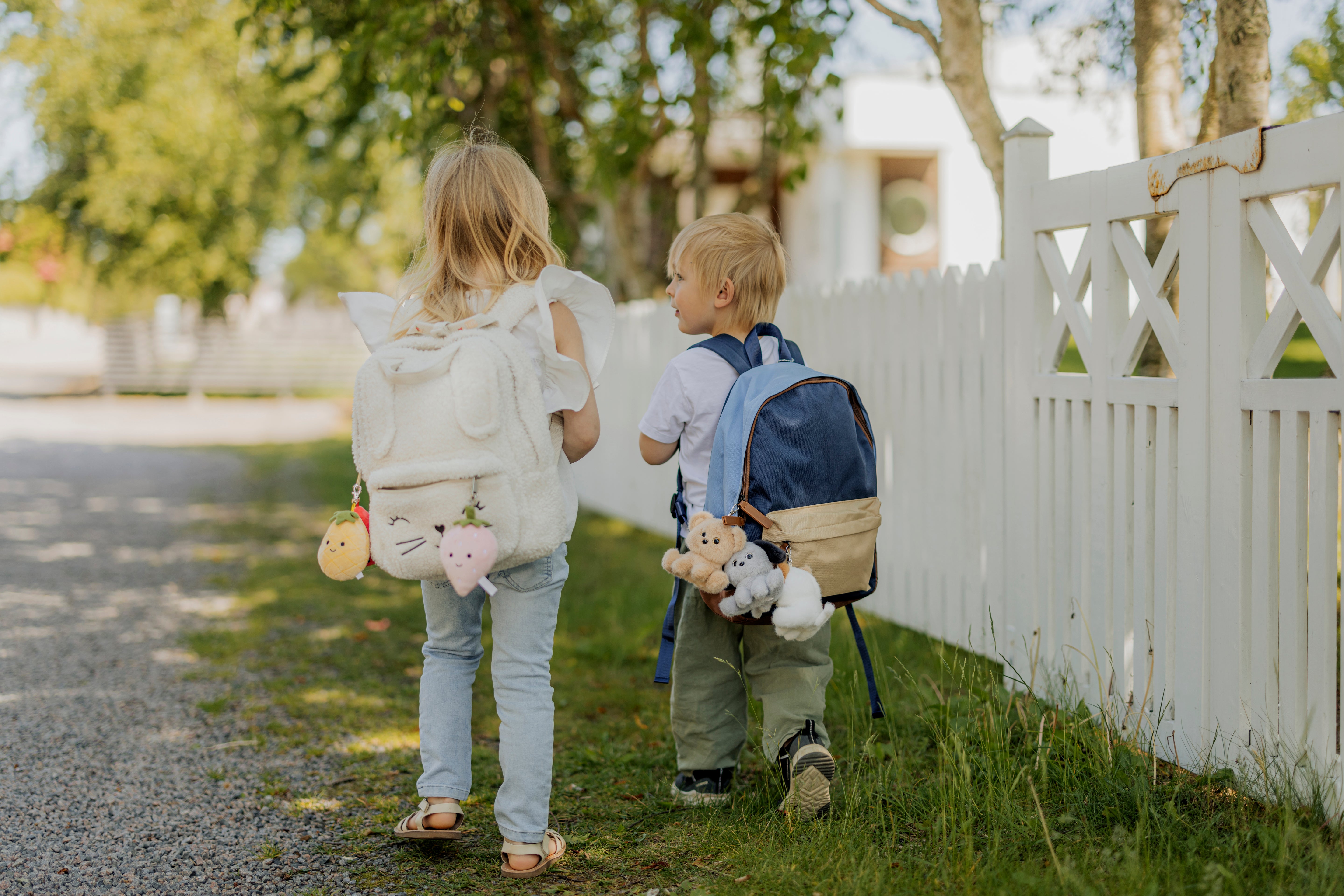 Image of files/4368_4367_2KidsWalkingFence_HIGH_d7353f56-798b-4962-a202-19c429009048.jpg