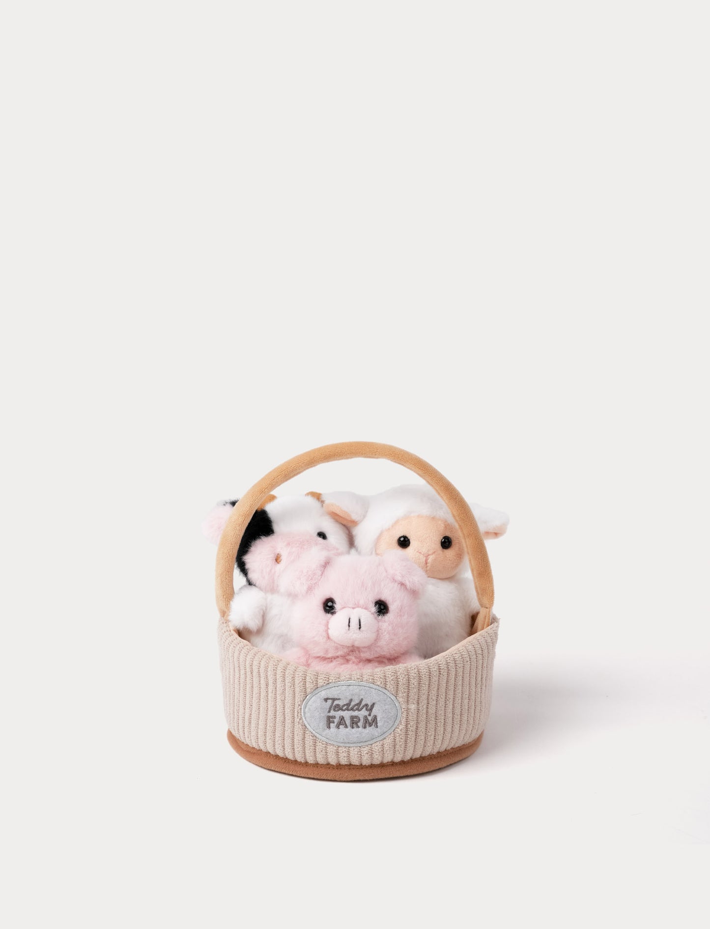 Plush toy animals in a basket with 'Teddy Farm' label on a white background