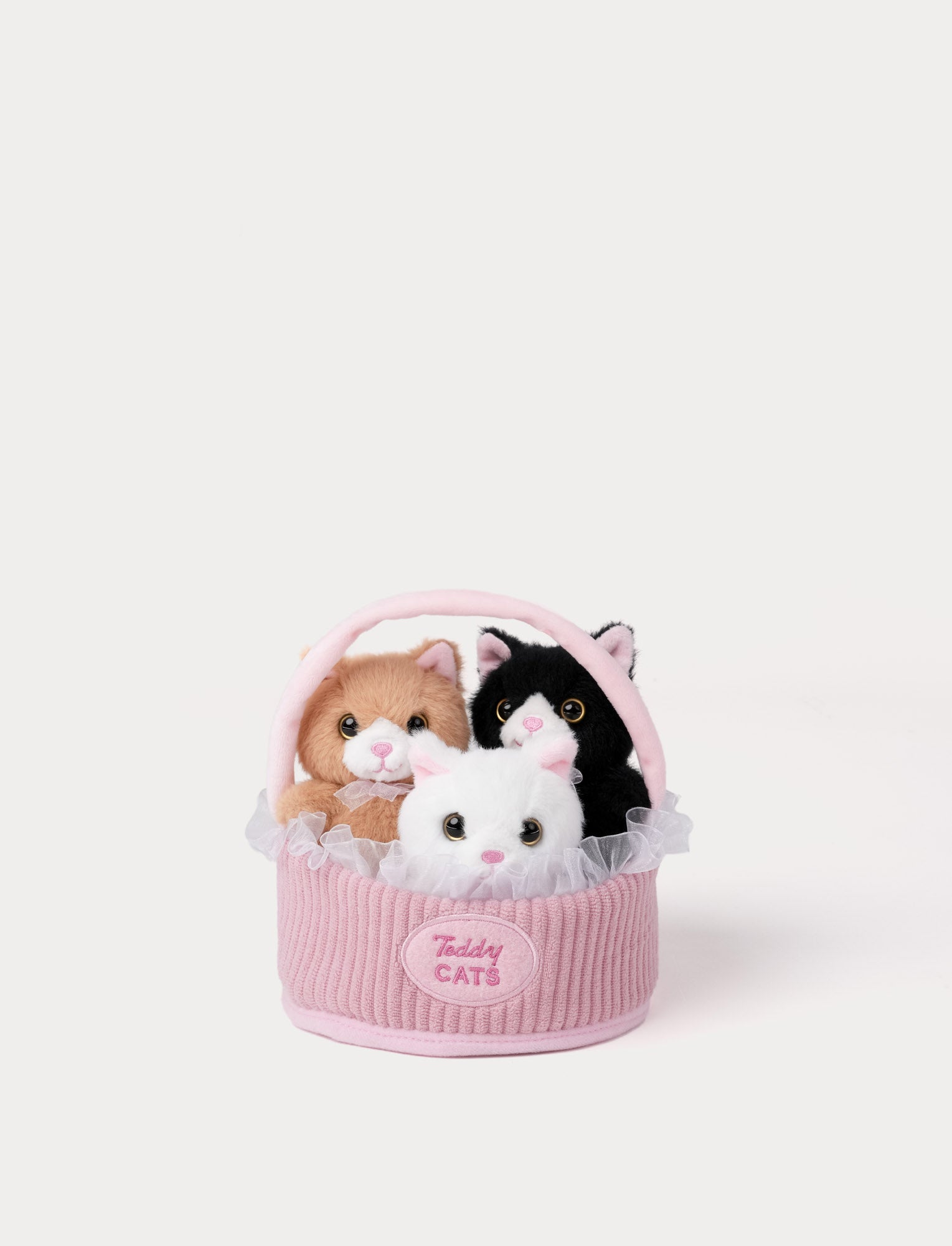  Image of Small plush toy cats in a pink basket on a white background