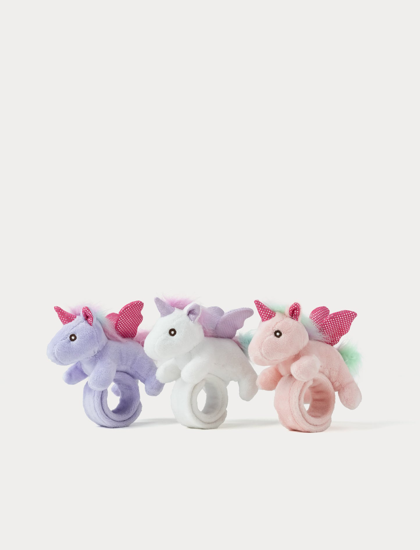Three pastel-colored unicorn snap wrisbands