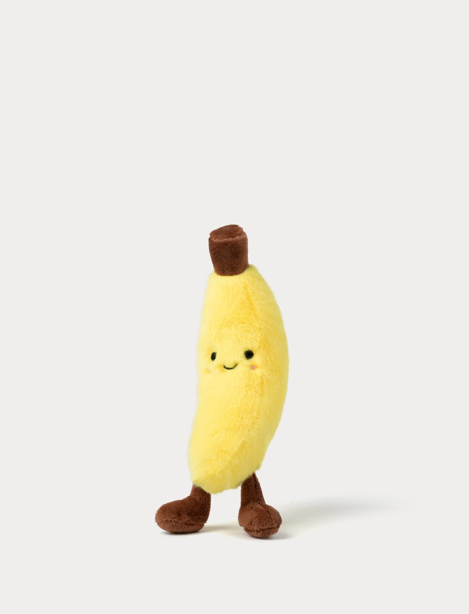  Image of Plush banana toy with a smiling face on a white background