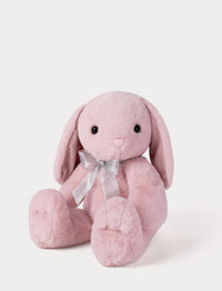 Pink plush bunny with a bow on a white background