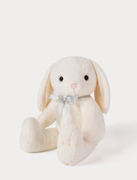 White plush bunny toy with a bow on a white background